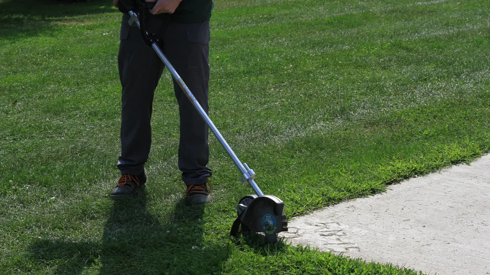 Crisp mower stripes running alongside a sharply edged walkway